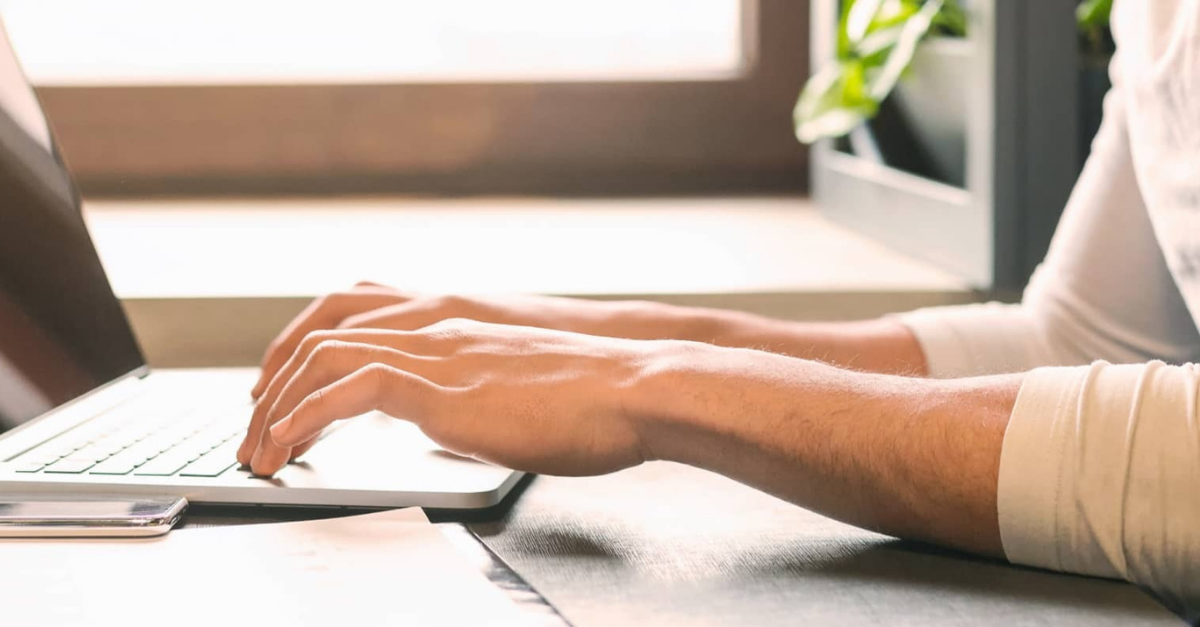 Hands typing on keyboard