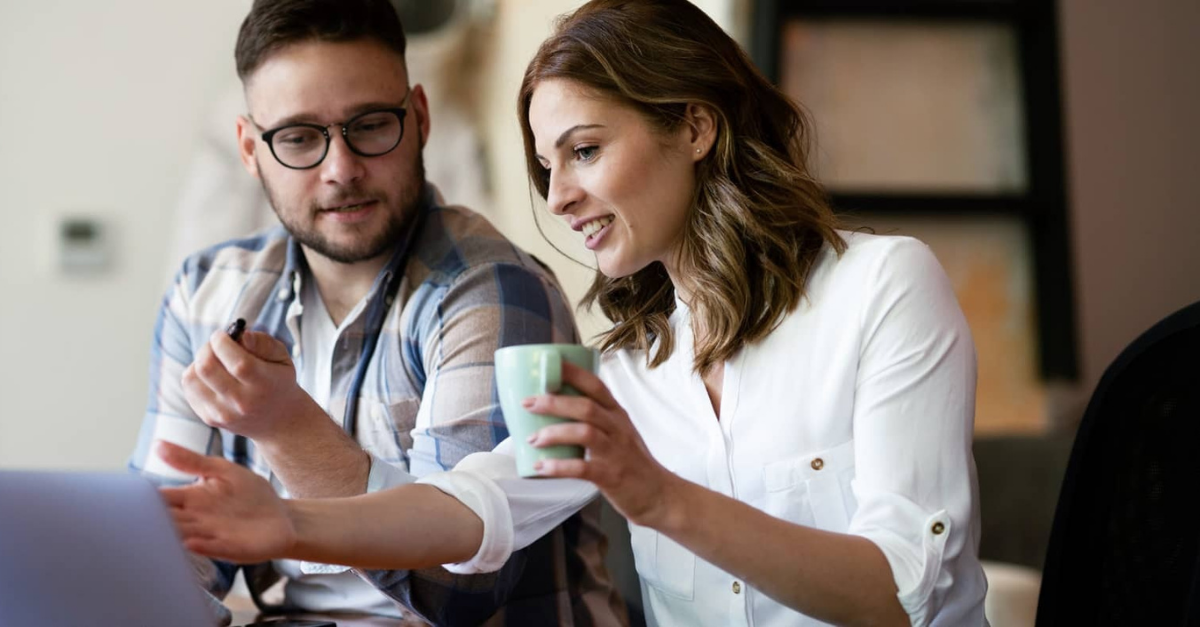 Man and women talking at computer