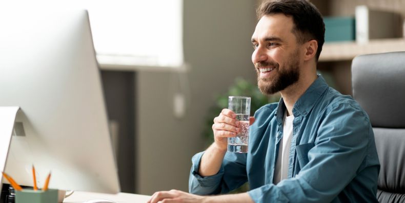 Man smiling at laptop