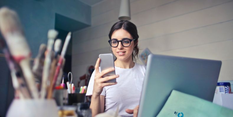 woman using her phone in an design studio